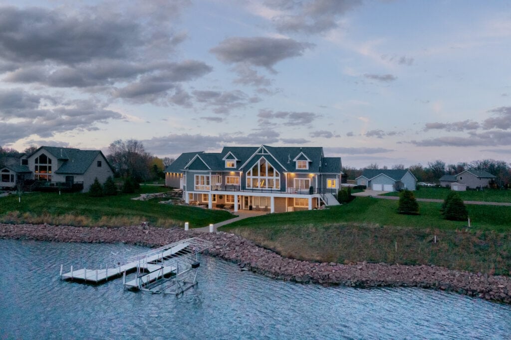 Architectural drone photo of a backyard view of lake home in Minnesota