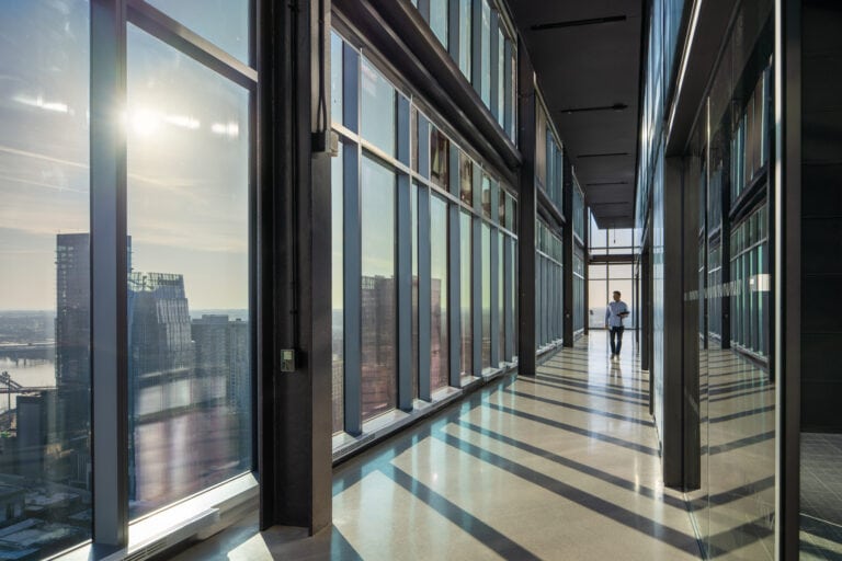 Man walking down corridor of high-rise in downtown Nashville