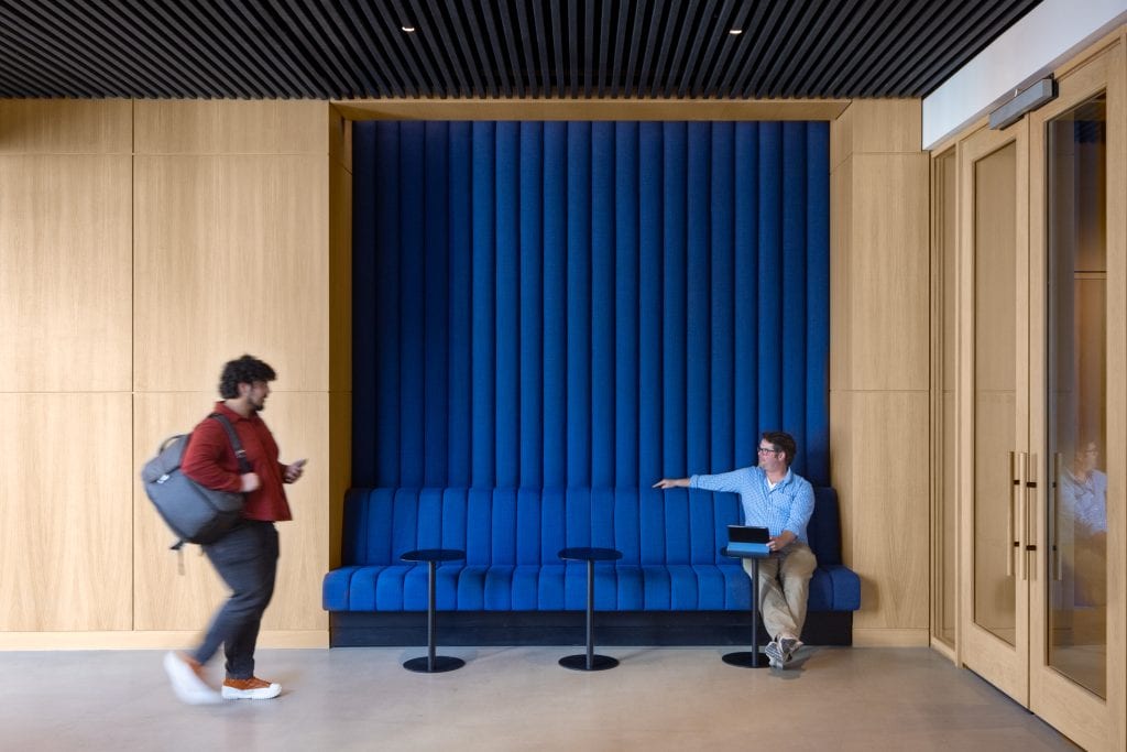 Men working in an common space in a New York office. Commercial Architectural Photographer.