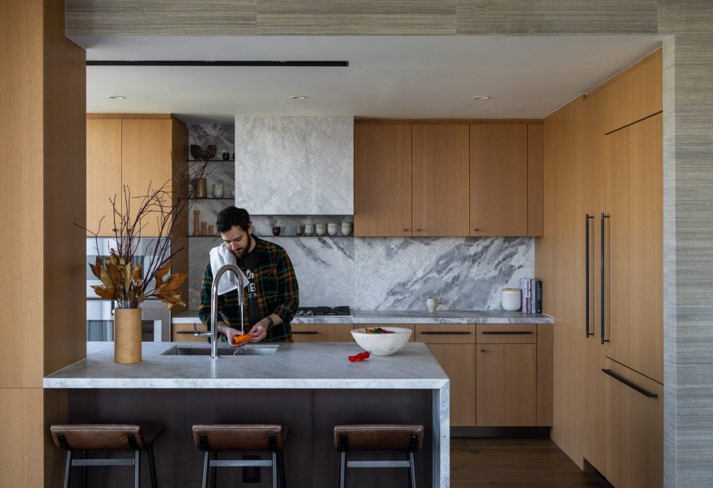 Man working in the kitchen in a New York City apartment