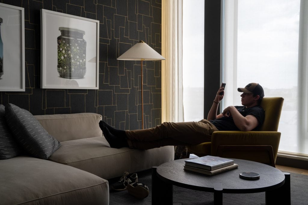 Interior photography of a man lounging in his New York City den 