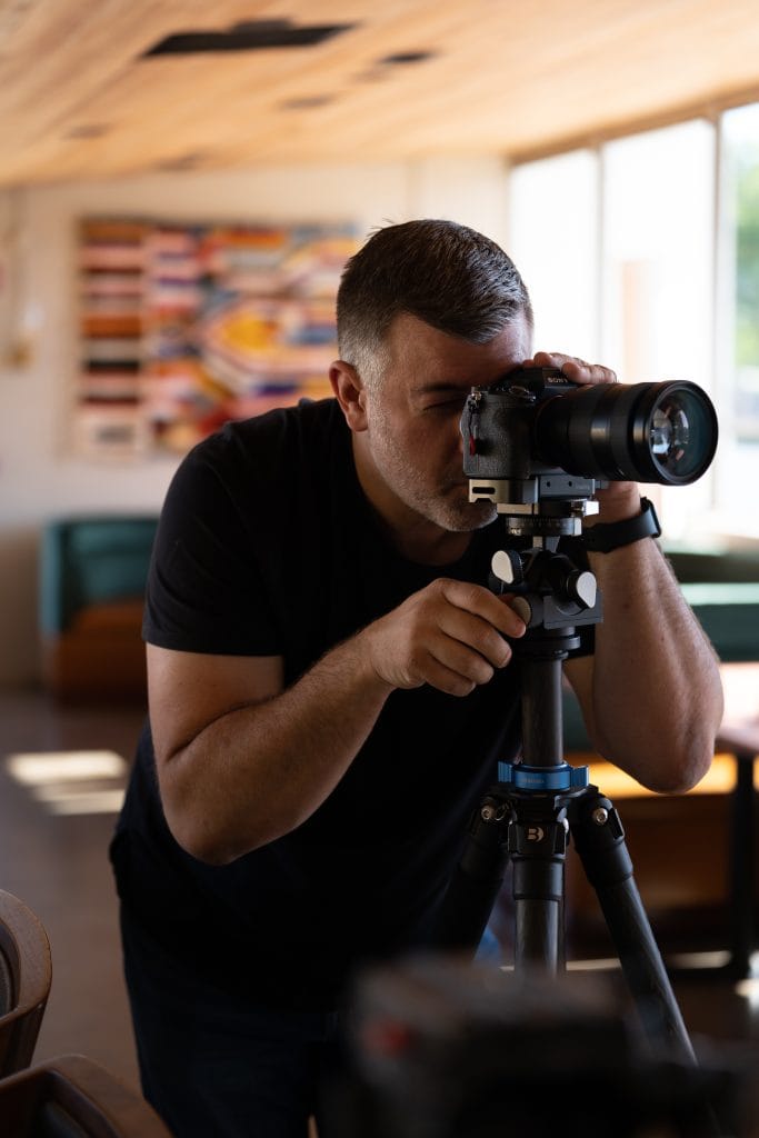 Behind the scenes photo of Nashville Architectural Photographer Jordan Powers with camera and tripod