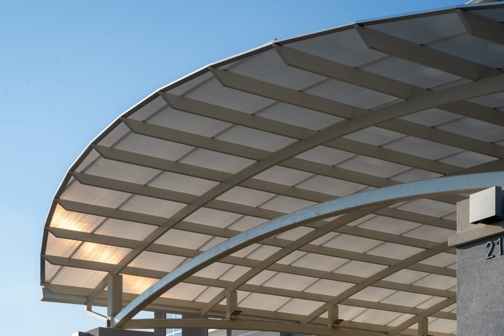 Architectural details of the underside of an awning capturing polycarbonate material used to create the roof.