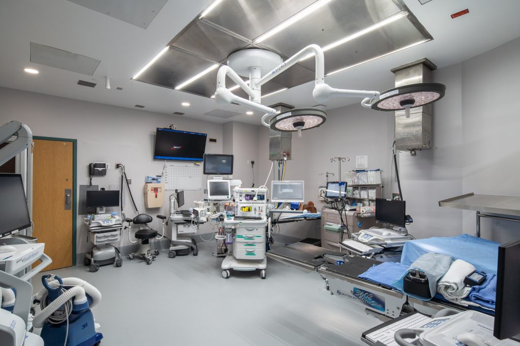 Wide-angle view of an operating room in which a state-of-the-art led light panel lines the ceiling.